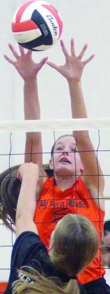 Emmrie Marx deflects a Brazos attack in the first scrimmage Friday. Sticker Photo By Darrell Vyvjala