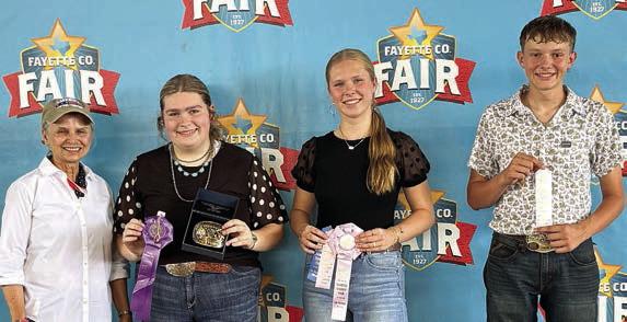 Overall High Point Seniors – (from left) buckle sponsor Elaine Thomas, in memory of Emil Thomas; Rheagan Karisch of the Pure Country 4-H, first; Madison Markwardt of the Round Top-Carmine 4-H, second; and Holden Holub of the Schulenburg 4-H, third.
