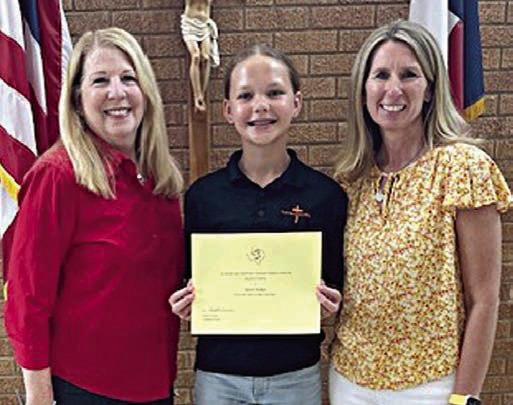 Third place winner Keaton  Watkins from St. Anthony Catholic School in the center, flanked by NVCW “Beef for Father’s Day” chair Suzette Surman and St. Anthony principal Shawna Collins