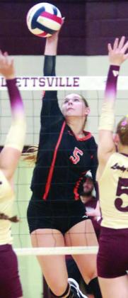 Haylee Vacek goes up high to send down one of her 30 kills against Hallettsville. Sticker Photo By Darrell Vyvjala