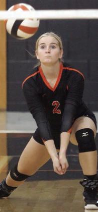 Madison Kunschick sends a pass on its way in the first set Saturday morning. Sticker Photo By Darrell Vyvjala