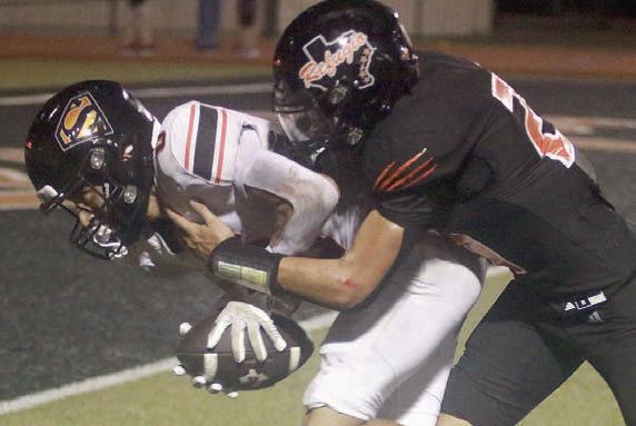 Denver Carr drags a Bobcat to the end zone after a fourth-quarter reception for the Horns’ first touchdown of 2026. Sticker Photo By Darrell Vyvjala