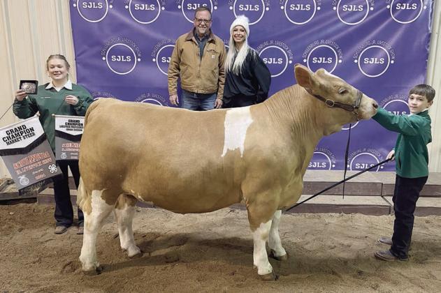 STEER – Exhibitor: Crockett Guenther (right). Weight: 1,430 pounds. Sales price: $10,000. Sticker Photo By Darrell Vyvjala