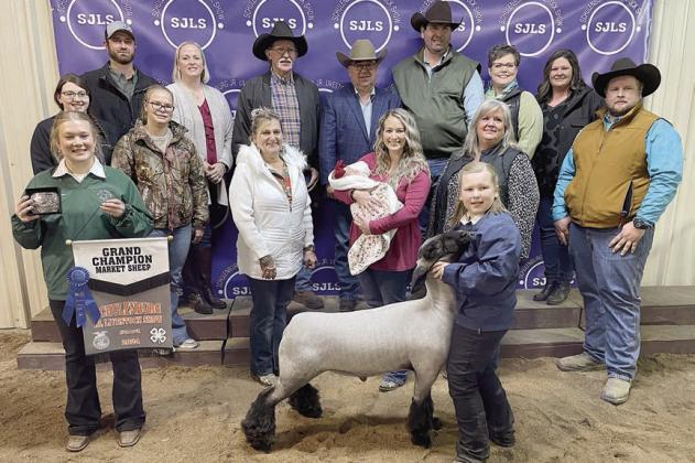 LAMB – Exhibitor: Olivia Otto (front, right). Weight: 148 pounds. Sales price: $8,100. Sticker Photo By Darrell Vyvjala