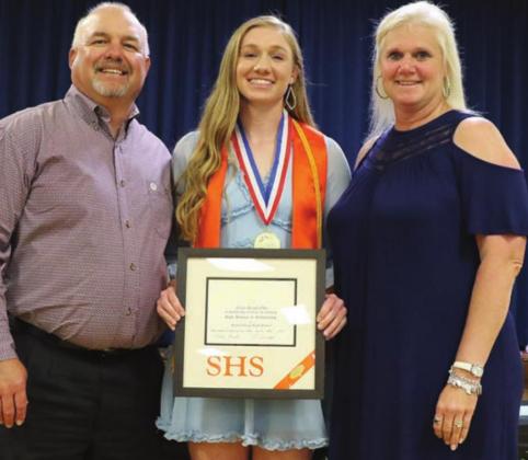 Erica Otto (center), along with her parents Keith and Stacy, receives the salutatorian award. Photo By Audrey Kristynik
