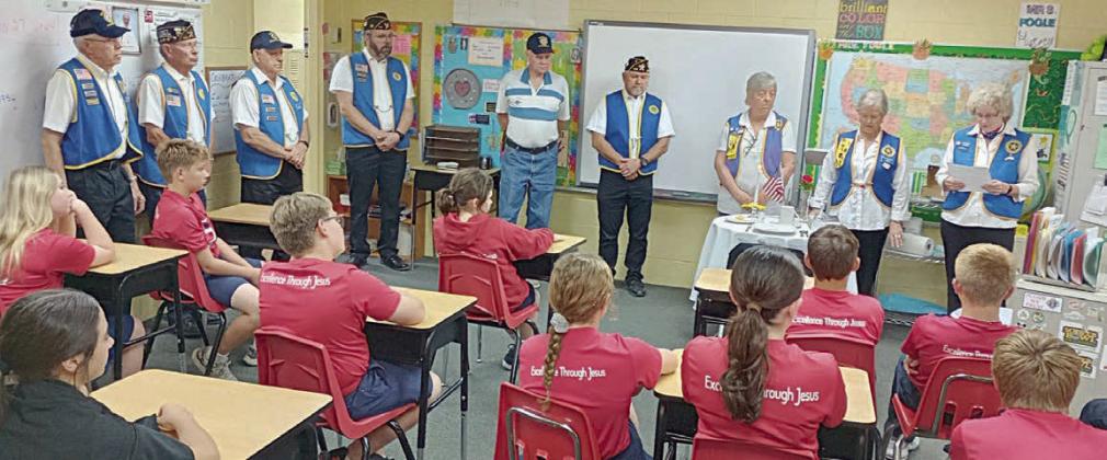 Members of the Legion Auxiliary and American Legion shown holding the POW/MIA ceremony at St. Rose of LIma Catholic School are (standing in back, from left) Wesley Holub, Eugene Krupala, Jack Niesner, Rick Todd, James Brown, Jesse Lednicky, Debbie Behlen, Patricia Hranicky and Barbara Brown.