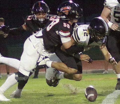 Preston Kahn sacks Tyson Sisneroz in the second quarter and dislodges the ball, which Rogers was able to recover. Sticker Photo By Layne Vyvjala