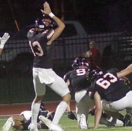 Colton Richburg (No. 13) gives the signal for a safety after the Eagle kickoff returner was dropped in the end zone by Emerson Harvey (No. 9) and Brock Schramek (No. 63) in the second quarter. Sticker Photo By Layne Vyvjala