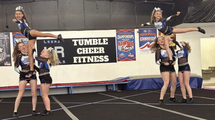 Performing A stunt – (from left) Paisley Baladez, Bebe Pavlica, Brooklyn Beeman, Ava Baladez, Lexi Pilat and Lennon Demel. Sticker Photo By Diane Prause