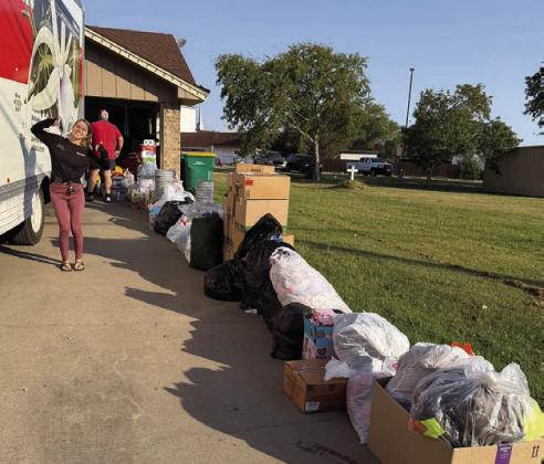 Hurricane relief – Jasmine Calvert is shown with all of the donations collected at the Senior Connections Schulenburg campus in one day to be sent to Georgia for hurricane relief. The garage in the back is totally filled with other donations – enough to fill a 26-foot U-Haul. This is what community looks like.