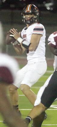 Aaron Janecek surveys the field before hitting Byron Johnson downfield in the first half last Friday in Flatonia. The senior quarterback completed all 11 of his passes, totaling 180 yards, in the Shorthorns’ 63-24 win. He finished the regular season 104-for-159 (65.4 percent) for 1,787 yards with 20 touchdowns and five interceptions. For complete coverage of the game against Flatonia, see SPORTS. Sticker Photo By Darrell Vyvjala