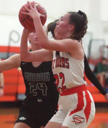 Julie Guentert drives in for a basket in last Friday’s game against Marian. Sticker Photo By Darrell Vyvjala