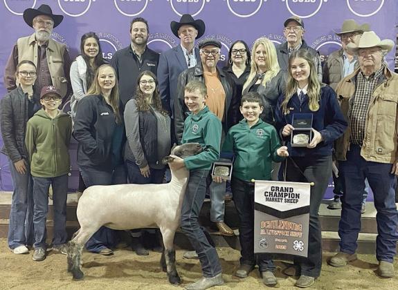 SHEEP – Exhibitor: Holden Holub (front, left). Sales price: $8,000. Sticker Photo By Darrell Vyvjala