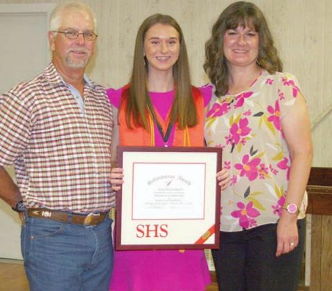 Jordan Sommer (center), along with her dad and mom, James and Melissa, receives the salutatorian award at the Senior Scholarship and Academic Banquet. Sticker Photo By Darrell Vyvjala