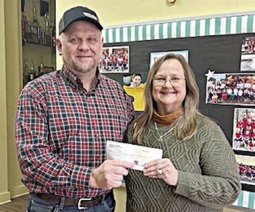 Grand knight Paul Zapalac (left) represents KC Council 2902 in presenting the contributions to St. Rose principal Rosanne Gallia (right).