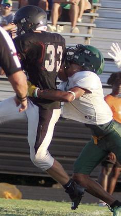 John Davis drags an Eagle defender to finish off a 19-yard run. Sticker Photo By Darrell Vyvjala