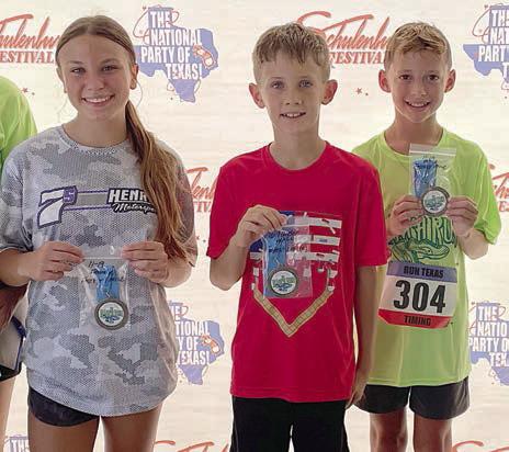 One-mile winners – (from left) Ellie Hammack, 11-19 female; Tripp Brown, 10 &amp;amp; under male; and Levy Herrera, 11-19 make. Not shown: Judy Falke, 20 &amp;amp; over female. Sticker Photo By Darrell Vyvjala