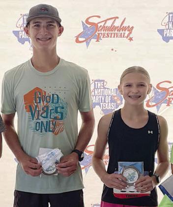 Overall 5K winners – (from left) Ty Lewis and Avery Lewis. Sticker Photo By Darrell Vyvjala