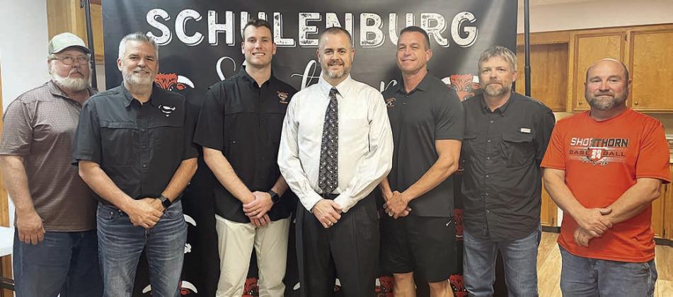 Welcoming Dr. Jerrod Barton (center) after his hiring as the new secondary principal last Wednesday are: (from left) Schulenburg ISD Board of Trustees President Mike Zweschper, Superintendent Lee Hafley, Trustee Hale Hentges; (from right) trustees Jarrod Schramek, Joel Blansitt, and Shannon Hollas. Sticker Photo By Darrell Vyvjala