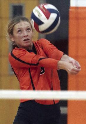 Michaela Kollmann sends a pass on its way in the first set against Smithville. Sticker Photo By Darrell Vyvjala