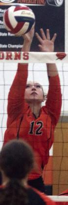 Grace Schramek deflects an attack during last Tuesday’s match. Sticker Photo By Darrell Vyvjala