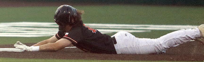 Owen Brenek slides safely into third base to finish off his triple in game three. Sticker Photo By Darrell Vyvjala