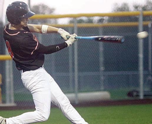 Emerson Harvey sends a hit to left field in game three, driving in two runs. Sticker Photo By Darrell Vyvjala