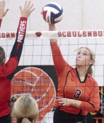 Reagan Dusek directs an attack past a Lady Panther for a kill in the second set. Sticker Photo By Darrell Vyvjala