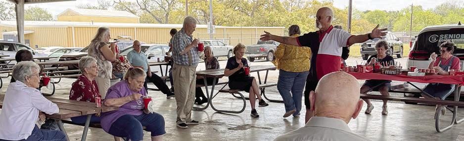 After a fire drill, Rusti Beckmann (standing with arms outstretched) addresses Senior Connections members. Safety is a big concern for members, and they responded quickly, quietly and calmly as they exited the building in record time! Beckmann has a vast background in fire safety and was a strong leader.