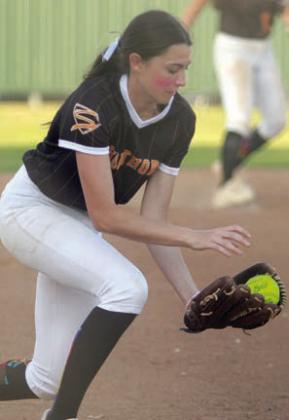 Third baseman Ava Faith come up with a hard-hit grounder for an out Friday. Sticker Photo By Darrell Vyvjala