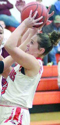 Grace Schramek pulls a rebound away from a Maiden in the first quarter. Sticker Photo By Darrell Vyvjala