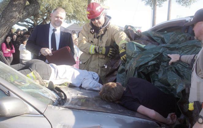Fayette County Precinct 4 Justice of the Peace Paul Zapalac (left) conducts an inquest, resulting in the death pronouncements for the two ejected accident victims. Assisting him at the mock scene were Schulenburg Volunteer Fire Department First Assistant Chief Drew Brossmann (center) and Fayette County Sheriff’s Department Deputy Rick Bohlmann (right). Sticker Photo By Darrell Vyvjala