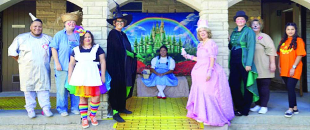 A Wizard of Oz theme was carried out at the Halloween Spooktacular. Shown are (from left) Parents As Teachers staff Josue Rivas, development director; Windi Raphael, parent educator; Tara Stech, parent educator; Sherise Davis, parent educator; Gina Sanchez, parent educator; Sonya Roberts, parent educator; Kristi McBride, executive director; Karen Hoskins, program director; and Lorena Hernandez; parent educator.