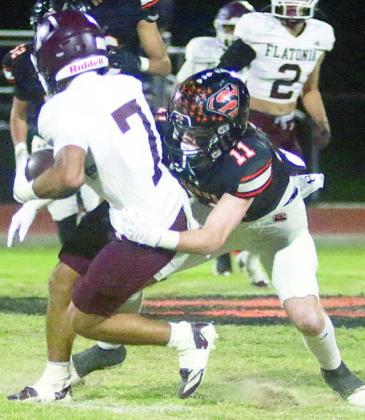 Nick Goode drops Zayden Perez for a loss of 5 in the first quarter. Sticker Photo By Brandt Vyvjala