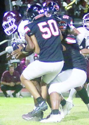 Jayden Olmos (No. 50) and Keigan Johnson team up to sack Jaylon Anderson in the first quarter. Sticker Photo By Brandt Vyvjala