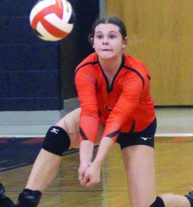Haylee Vacek gets to a short Lady Ricebird serve to send a pass in the first set Friday.