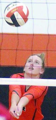 Avery Helms gets a dig in the back row early in Friday’s match. Sticker Photo By Darrell Vyvjala
