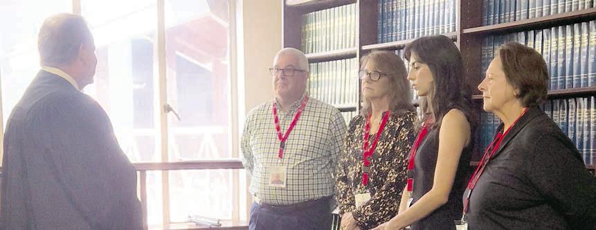 SHOWN At the swearing-in on July 29 for new CASA volunteers are (from left) Benton Eskew, court at law judge, who swore in Scott Davis of La Grange, Becky Herrin of Bastrop, Mary Jo Kilpatrick of Cedar Creek and Pamela Quarles of Elgin.