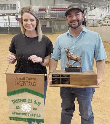 Livestock judging coaches (from left) Kaci and JoJo Carrales display the Sweepstakes Award earned by the Fayette County 4-H.