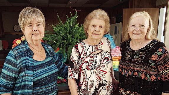 Hostesses were (from left) Bonnie Baker, Jerry Leonard and Janet Murphy.