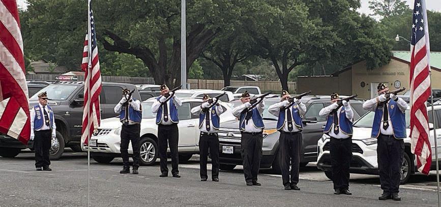 Post 143 members give the triple volley salute after the names of the 57 men from the Schulenburg area who lost their lives while serving were read. Sticker Photo By Darrell Vyvjala
