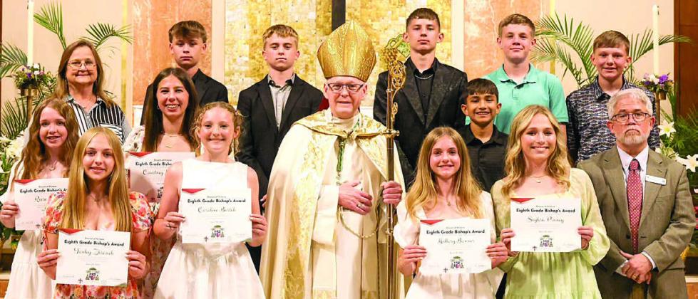 Shown at the Bishop’s Award presentation are (front row, from left) St. Rose students Tenley Zbranek, Caroline Bartek, Mallory Bonner and Saybra Pinney; (middle row) St. Rose students Reese Dusek and Courtney Magliolo; Bishop Brendan Cahill; St. Rose student Rilee Durfey; Robert Whitworth, diocese superintendent of Catholic schools; (back row) St. Rose principal Rosanne Gallia; and St. Rose students Brett Hollas, Weston Hollas, William Eudy, Bo Brossmann and Holden Holub.