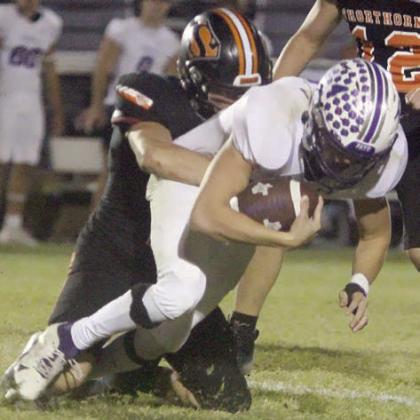 John Davis brings down Chance Parker for no gain late in the fourth quarter. Sticker Photo By Darrell Vyvjala