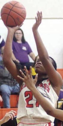 Jashiya Jackson drives to the basket for a first-half score last Tuesday. Sticker Photo By Darrell Vyvjala
