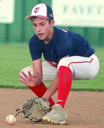 Shortstop Cal Schiffli (left) and second baseman Dylan Zweschper (right) scoop up ground balls for outs during Twin Cities’ District 13 championship game victory last Friday night at the Sports Complex. Sticker Photos By Darrell Vyvjala