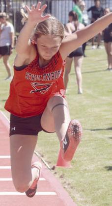 Michaela Kollmann leaps to a thirdplace finish in the triple jump. Sticker Photo By Darrell Vyvjala