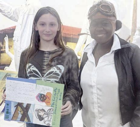 Holidng a poster titled ‘My Information on Bessie Coleman is Nevaeh Motley (left), shown with Rebecca Powe (right).