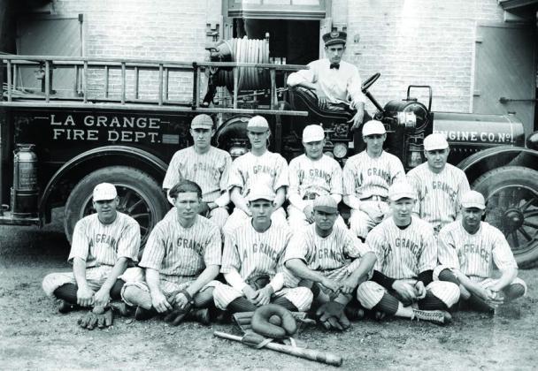 The La Grange Fire Department’s baseball team poses in front of an early fire engine and the Old Casino Hall, which had recently been converted from La Grange High School to a fire station. None of the men have been identified.