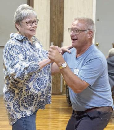 On the dance floor are volunteer Linda Heller (left) and Gary Pauler (right).
