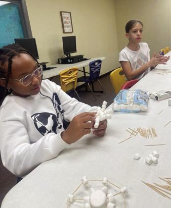 At the Schulenburg Unit of the Boys &amp;amp; Girls Club, members enjoyed crafting edible snowflakes using marshmallows and toothpicks last week. Shown are KeNilah Benford (right) and Cadence Gilliam (left).